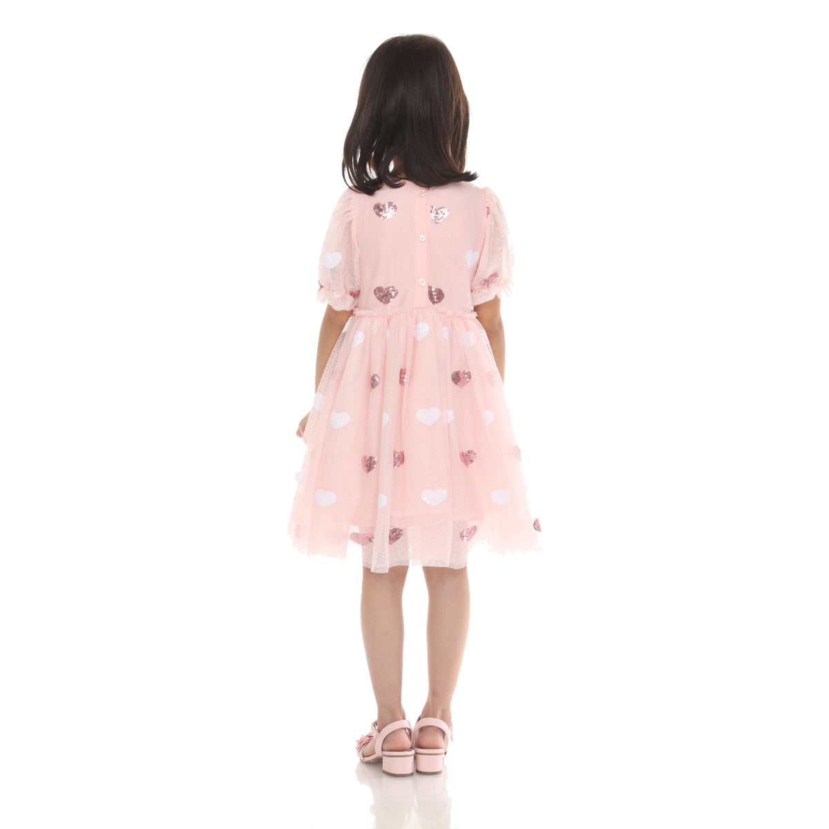 Back view of model in the Light Pink sequin heart babydoll dress with puff sleeves