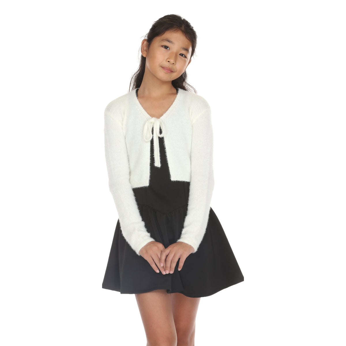 Model wearing the Ivory Tie Front Fuzzy Cardi tied at the neck over a black drop-waist dress